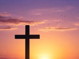a serene sunrise landscape with a cross silhouette