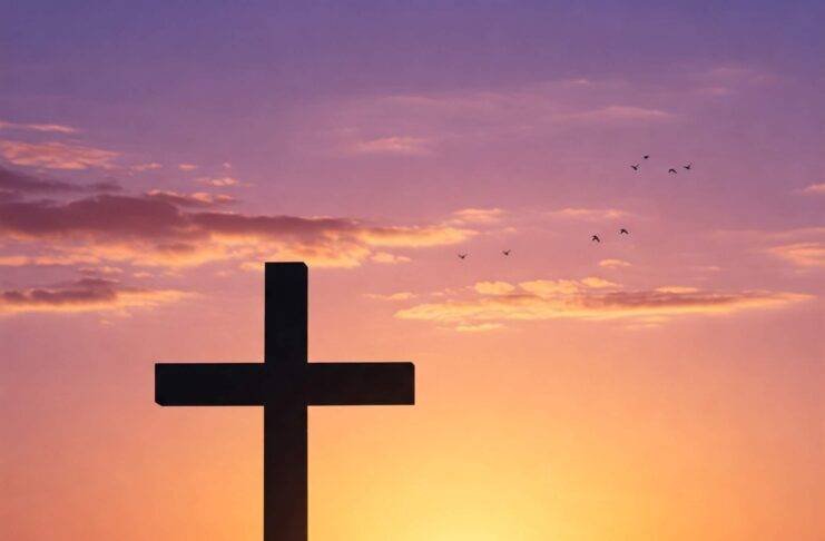 a serene sunrise landscape with a cross silhouette