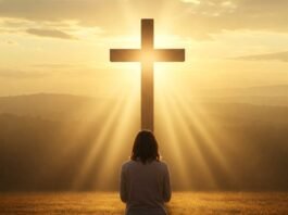 Person kneeling in prayer at dawn